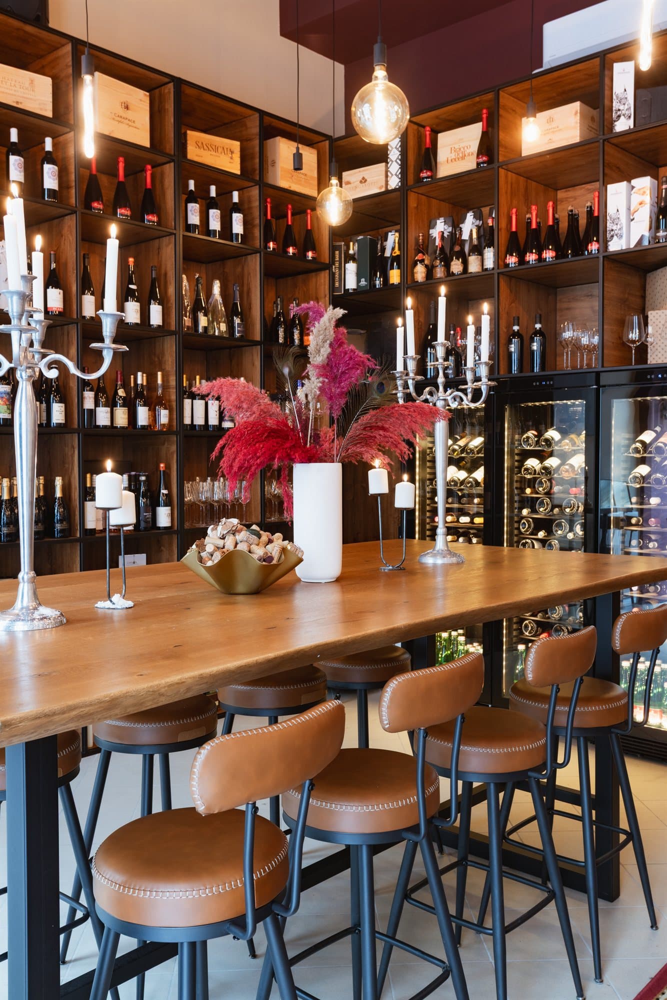 The main room, with its long communal table beneath a floor-to-ceiling wine wall