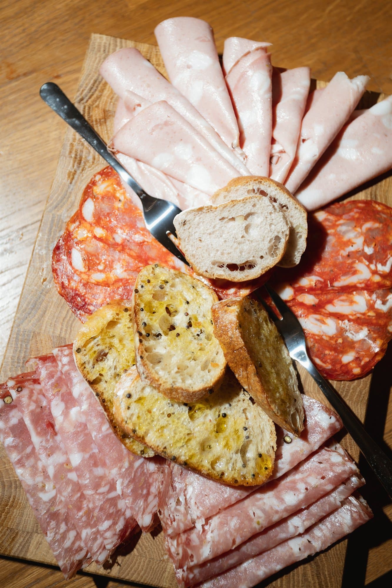 An Italian taglieri board of cured meats, cheese and grilled bread
