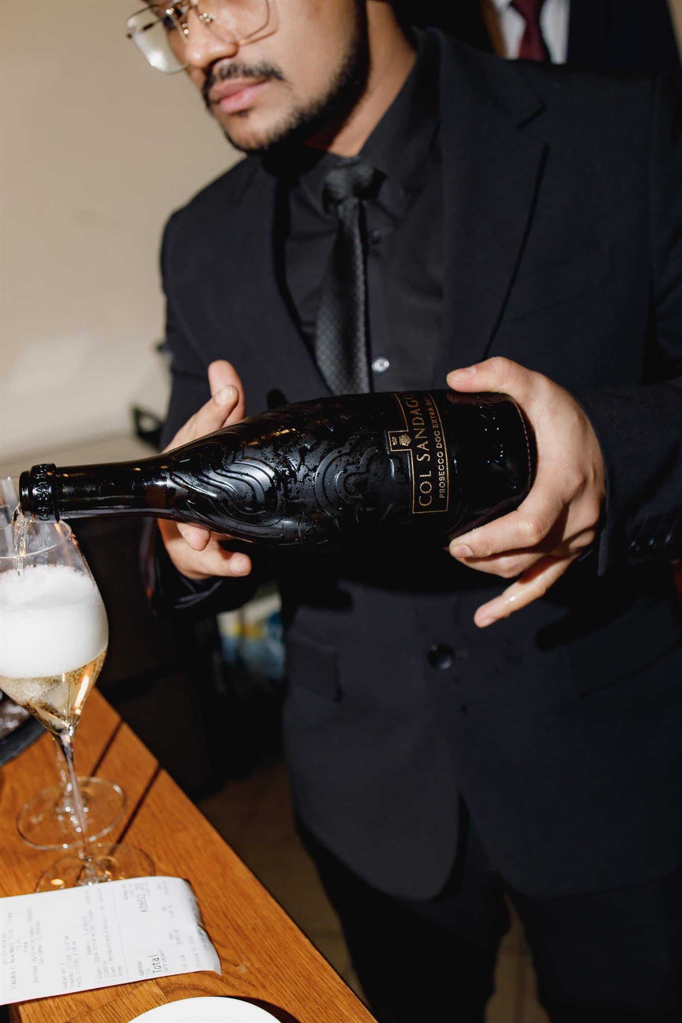 A sommelier pouring family-produced Prosecco into a glass